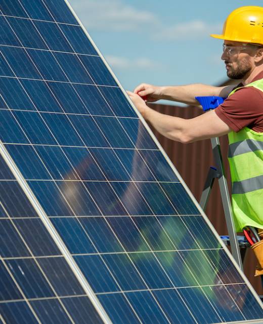 Serious engineer installing solar panel that helps to reduce electricity bills, dependence on foreign oil and fossil fuels